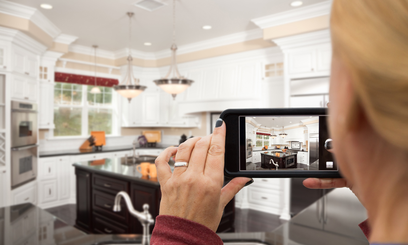 woman taking photo of the kitchen